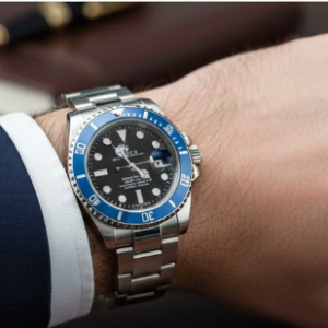 rolex silver tone submariner watch with a blue dial and bezel.